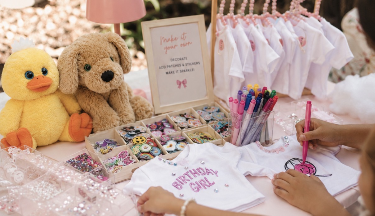 Decorating station with mini t-shirts, markers, stickers and patches